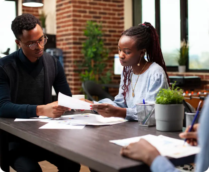 People discussing documents at a table